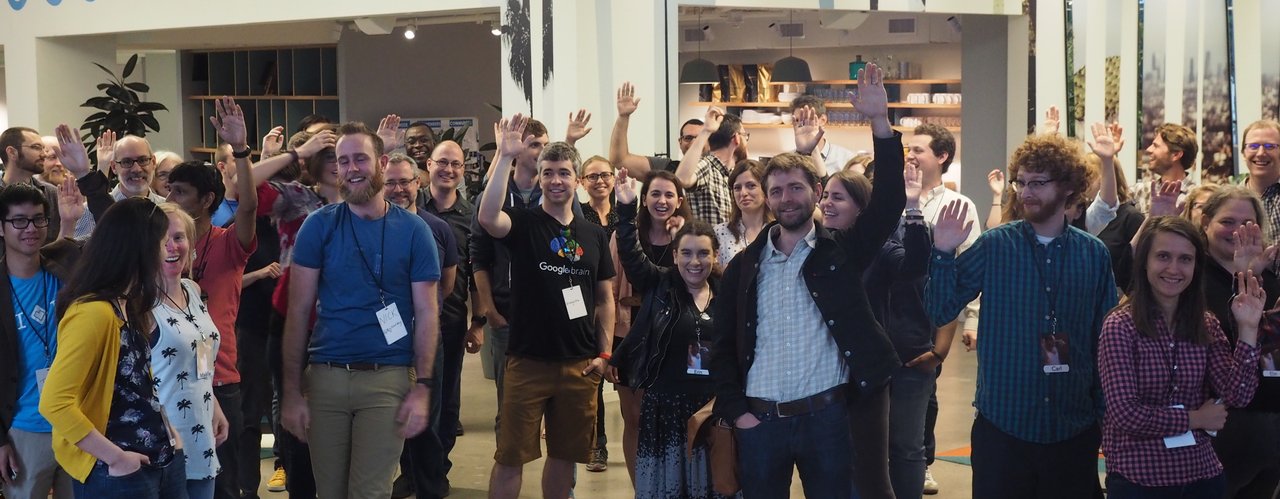 photo of 50 rOpenSci unconference participants standing facing the camera smiling and waving